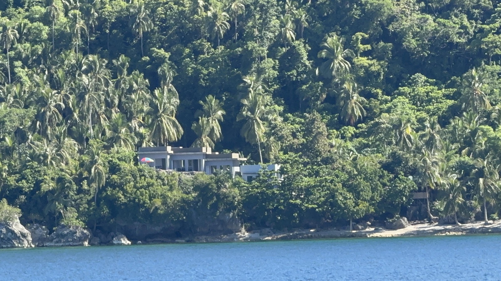 The resort nestled in the palm-covered hillside